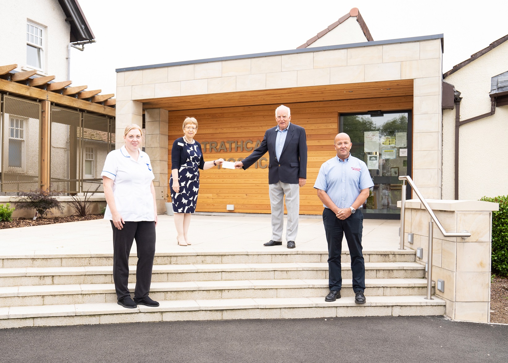  Tillicoultry Quarries director Wallace Menzies (second from right) presents a cheque covering the cost of renovations to Irene McKie (second from left), chief executive of the Strathcarron Hospice charity