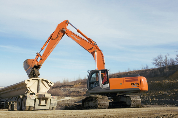 Hitachi excavtor emptying into truck