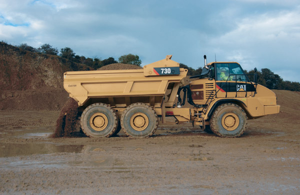 Caterpillar dump truck emptying at quarry 