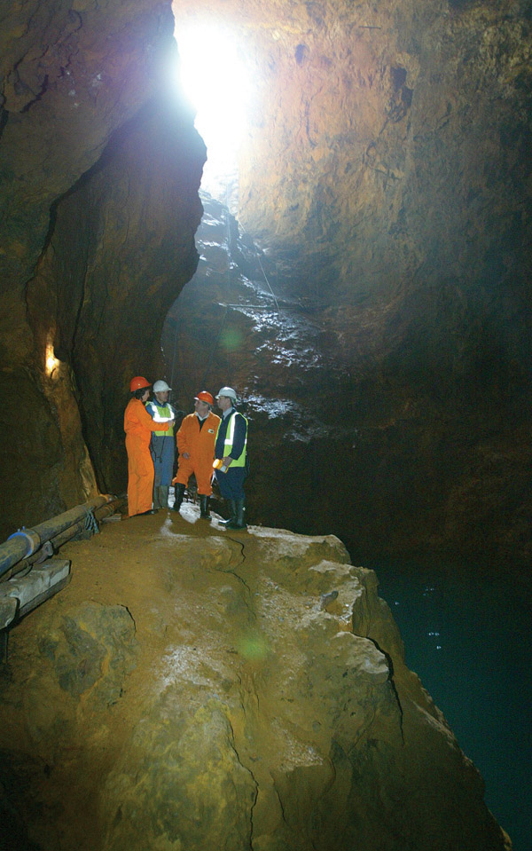 Four mend standing in mine shaft