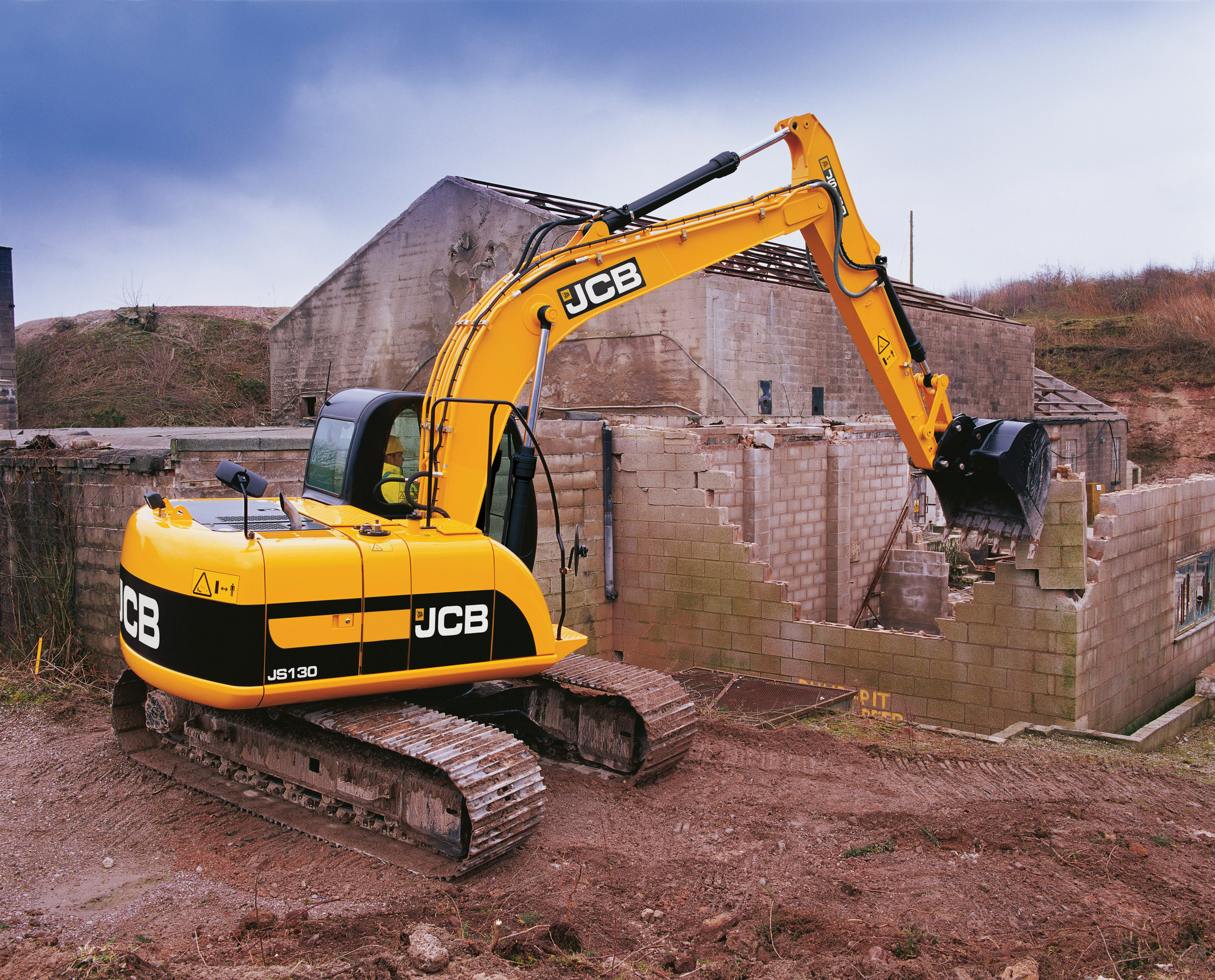 JCB excavator demolishing a building