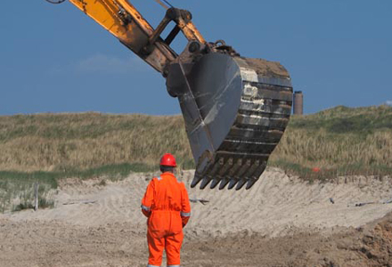 man standing near excavator arm