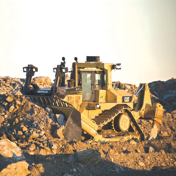 Cat D11T bull dozes rubble in quarry 