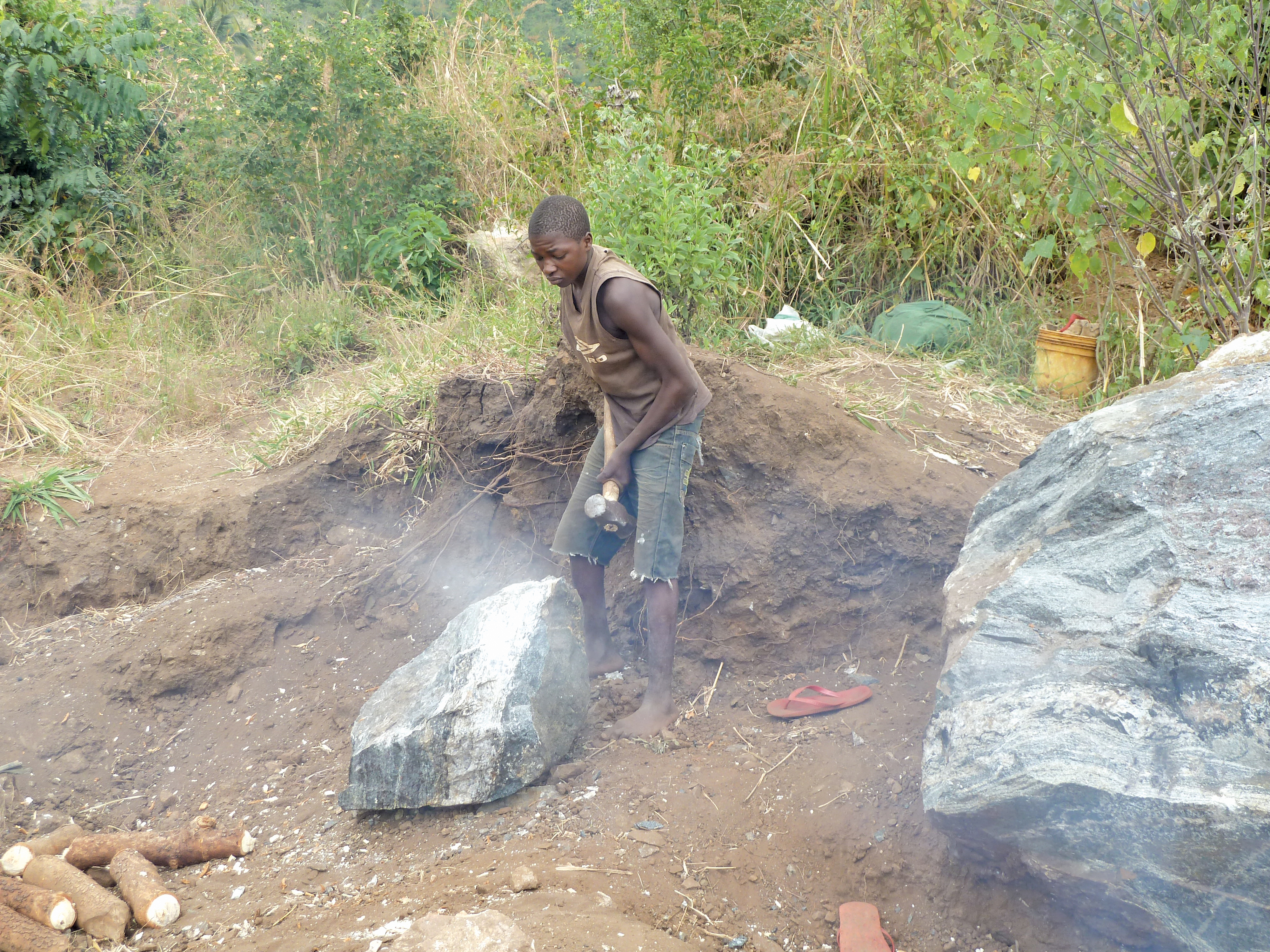 A boy breaking stones 