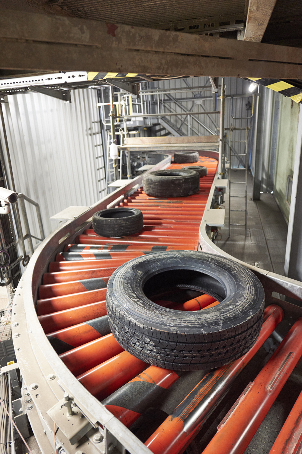 A roller conveyor, part of a wider system installed by BEUMER, guiding waste tyres to the next stage of the fuel-making process