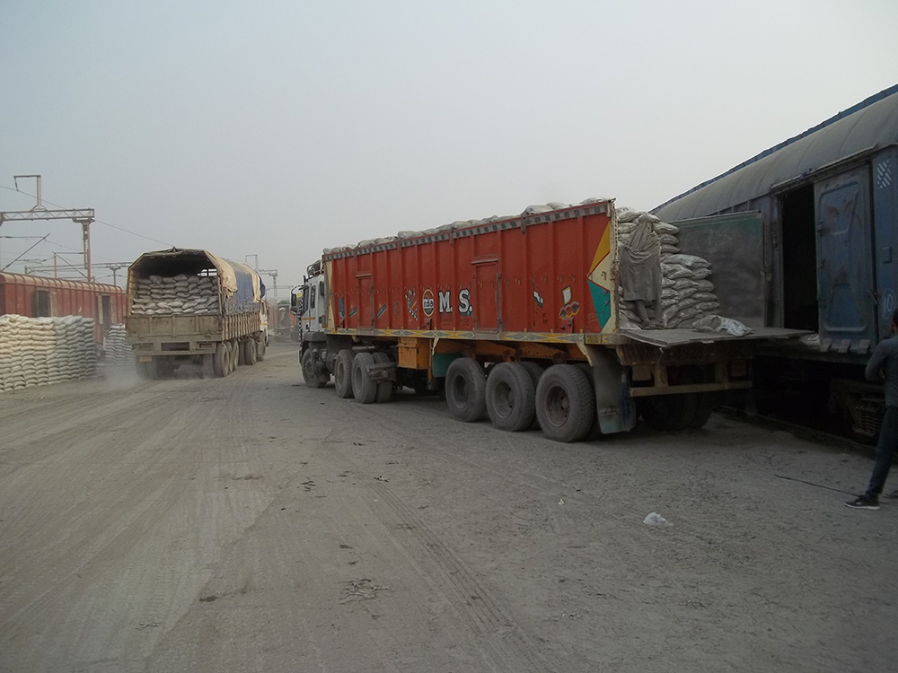 Bagged cement being transferred from railway wagons to trucks at a major cement terminal at Ghaziabad in Uttar Pradesh, north India