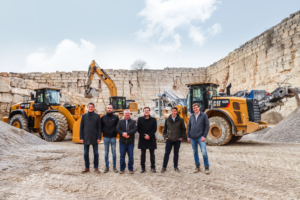 SH-Jura Steinbruch CEO Josef Seizmeir and his son Josef (3rd and 2nd from the right); Stefan Hausmann (right); Robert Schiller (3rd from left); Jürgen Karremann, Zeppelin sales director (left); and Daniel Bauer, Zeppelin sales manager (2nd from left)