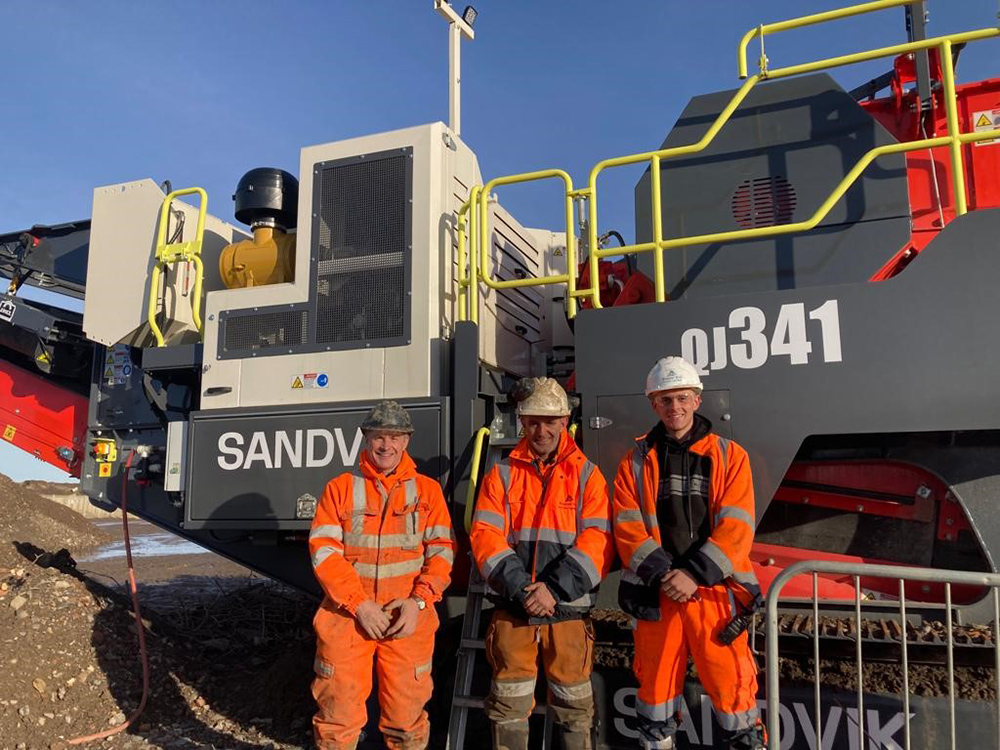 The Brewsters in front of the company’s new Sandvik QJ341 mobile jaw crusher