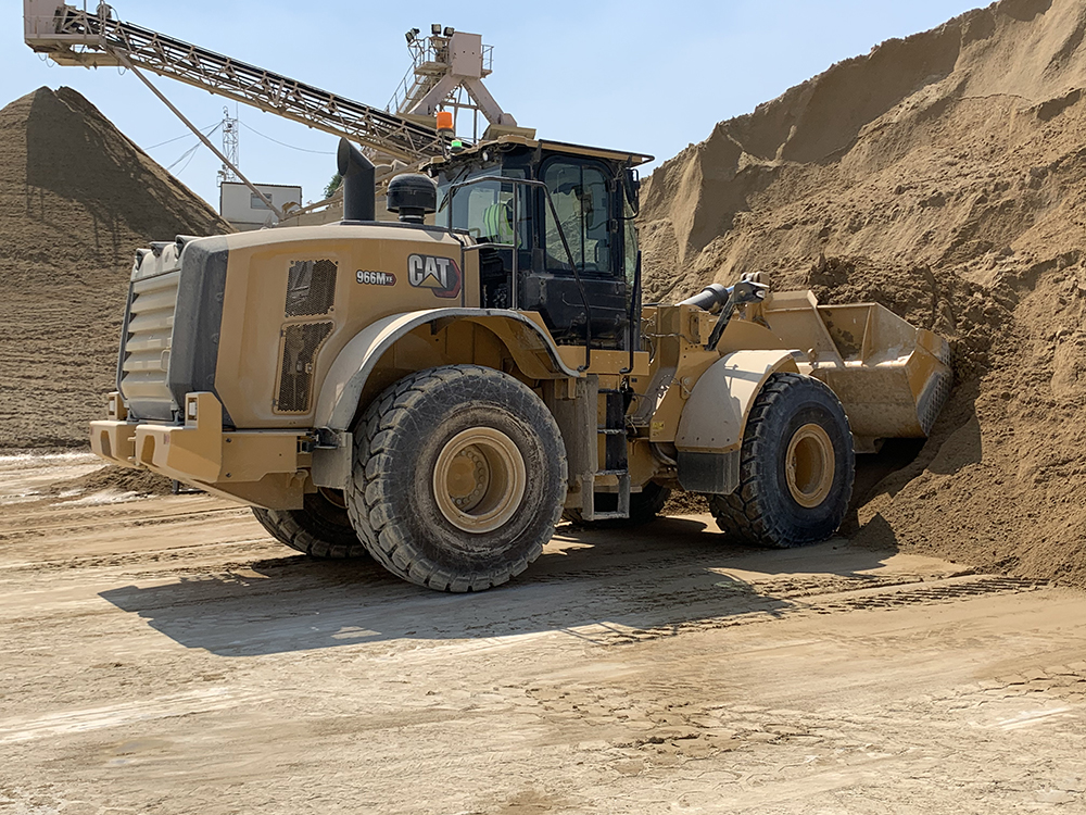 Latomia Latouros’s new Cat 966M XE wheeled loader gathering material