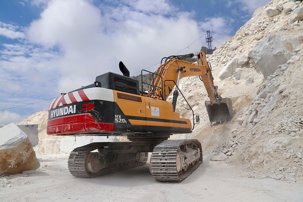 A Hyundai HX520L excavator working at the Colonnata marble quarry in Tuscany