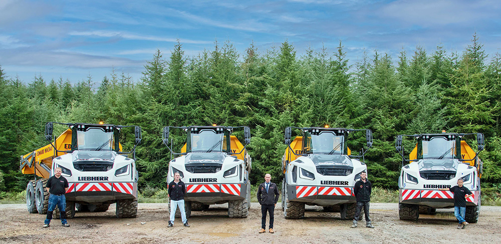 The Mackay Liebherr dump truck line-up complete with drivers, from left to right Grant Sutherland, Gordon Taylor, Eddie Mackay, Jamie Allan and Craig Pirie