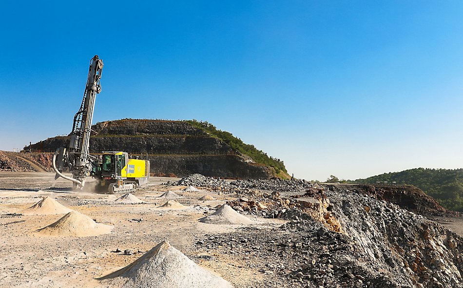 A PowerROC D55 DTH surface drill rig in action at Baota Hill Mine