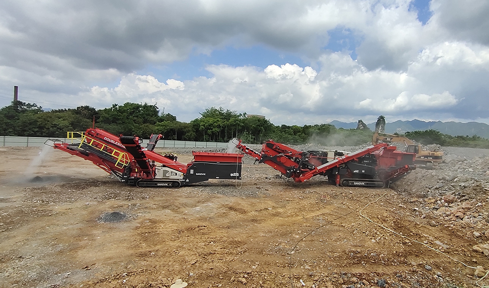 Hunan Yan Run’s Sandvik crushing and screening combination being fed with material by a Cat 320C crawler excavator