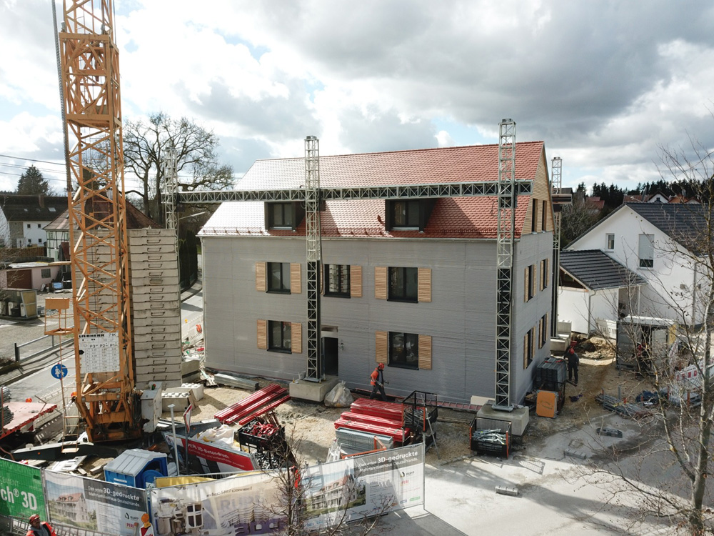 Europe's claimed first 3D printed three-storey apartment building in Wallenhausen, Germany, printed with a COBOD 3D printer. The video about this building has been viewed more than 1.6 million times on YouTube