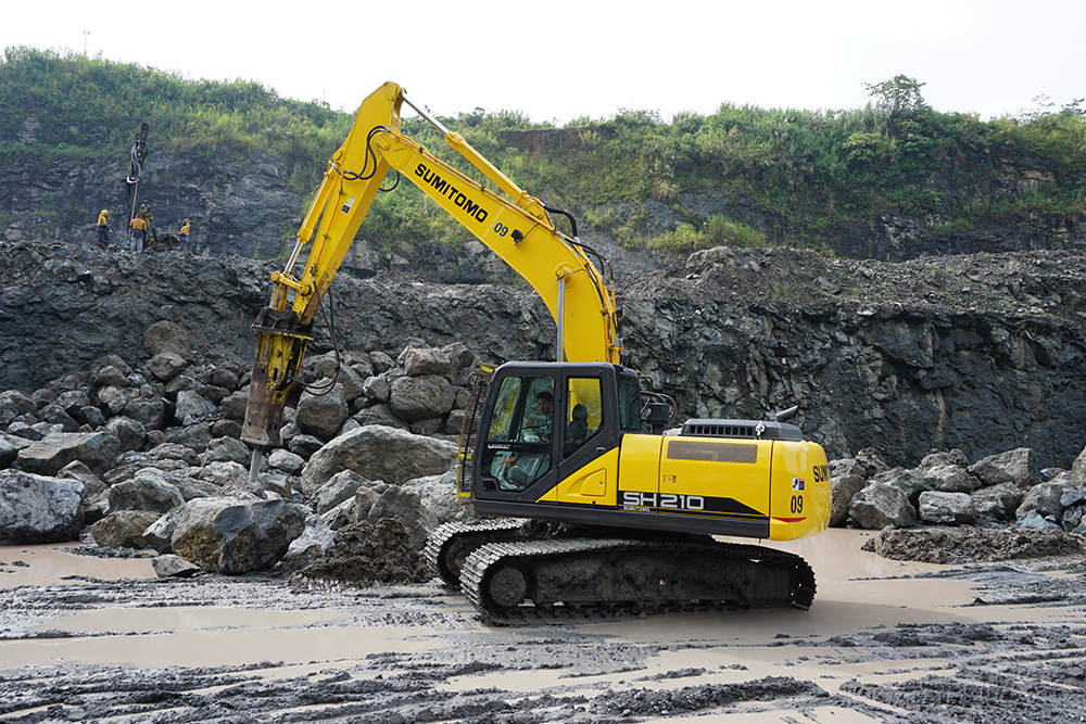 A Sumitomo SH210-6 excavator at work in an Indonesian stone quarry