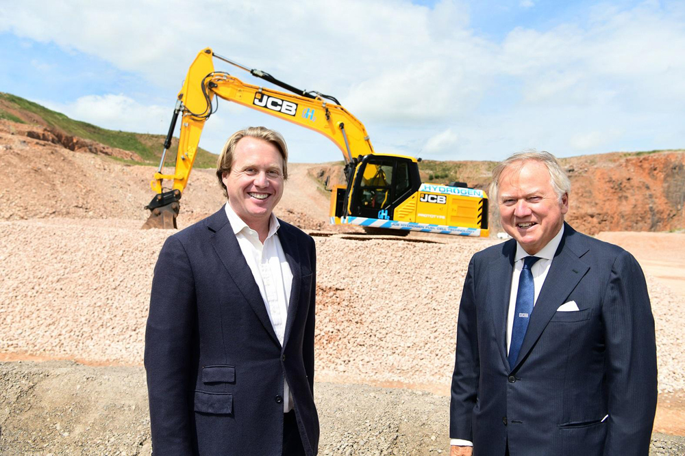 JCB chairman Lord Bamford (right) and his son Jo Bamford with the new 20-tonne JCB 220X excavator