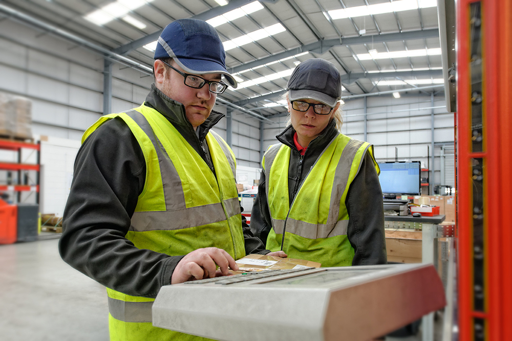 Two Terex parts facility employees at work