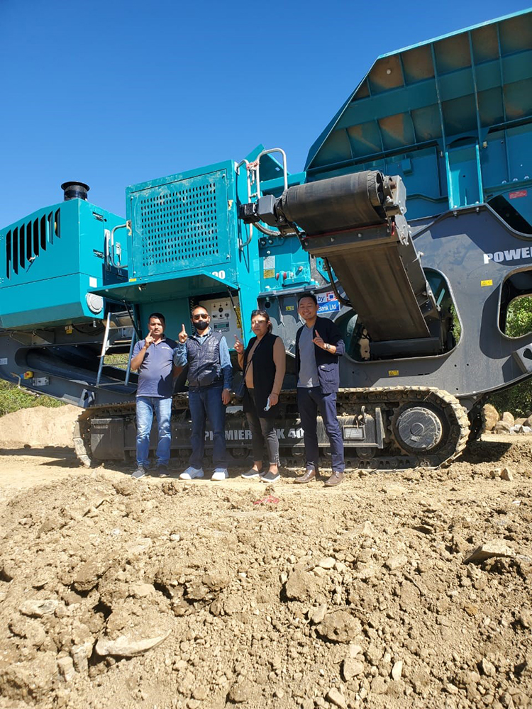 Jhandu Construction management in front of the company’s recently purchased Premiertrak 400 jaw crusher. The model will be used for road construction work in Nagaland state