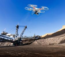 drone flies over a mining site