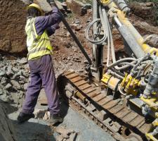 Quarry worker moving material prior to drilling.jpg