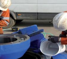 Workmen applying a cure to the crusher backing