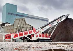 A Telestack LF520 stockpiling sand 