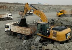 Cat excavator loading a dump truck