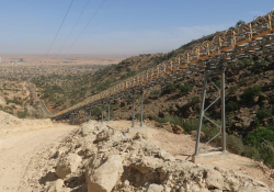 The conveyor is built on a mountain side to connect a quarry and cement plant