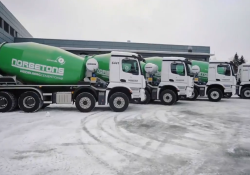 The five mixer trucks can turn off their diesel engines when they arrive on-site