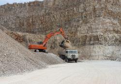 An MB Crusher excavator bucket is being used in Italy to prepare clean crushed rocks to be laid for new rail tracks, all done reusing available materials