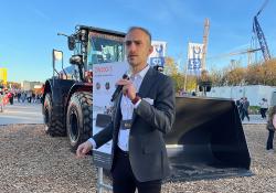 Hitachi Construction Machinery Europe’s Bill Drougkas at bauma with the new ZW250-7 wheeled loader. Image: Guy Woodford