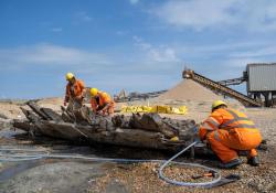 Researchers examining timbers from the shipwreck at the Cemex quarry site