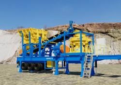 A Weir Minerals Trio TC51 cone crusher with conveyer and cone surge hopper for processing material