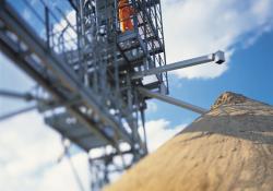 Operator over mound of sand