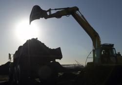 Excavator moving soil