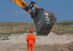 man standing near excavator arm