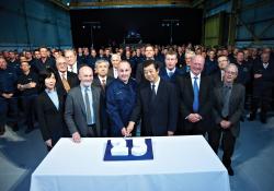 Guests and personnel gathered for the cake cutting ceremony as Komatsu UK 