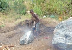 A boy breaking stones 