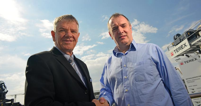 Gary Bell and Kieran Hegarty shake hands on the agreement