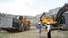 Volvo wheeled loader, Black Galaxy granite block