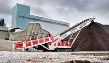 A Telestack LF520 stockpiling sand 