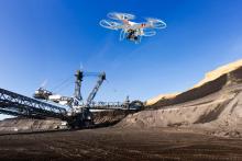 drone flies over a mining site