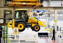 A JCB backhoe comes off the production line