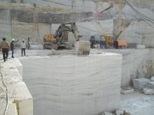 Volvo excavator being used by JK Natural Mables to push a large marble block away from the bench650.jpg