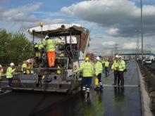 worker on a paver using high PSV aggregates