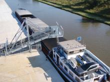 Barge at port with conveyor belt emptying