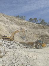 caterpillar excavator loading a truck