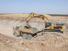 Cat loader putting minerals into a Cat truck