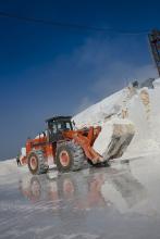 Hitachi loader carrying a block of marble