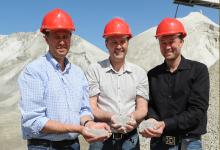 Egil, Harald and Reidar Velde holding sand